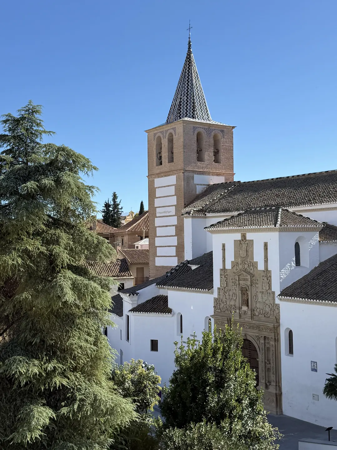 Church with a brick bell tower and tiled spire in a town along the Ride Trans Nevada route